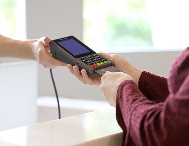 Patient inserting credit card into card reader